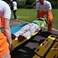 Emergency medicine technicians stretchering a patient Emergency medicine technicians stretchering a patient