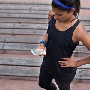 girl using Fitbit fitness watch girl using Fitbit fitness watch